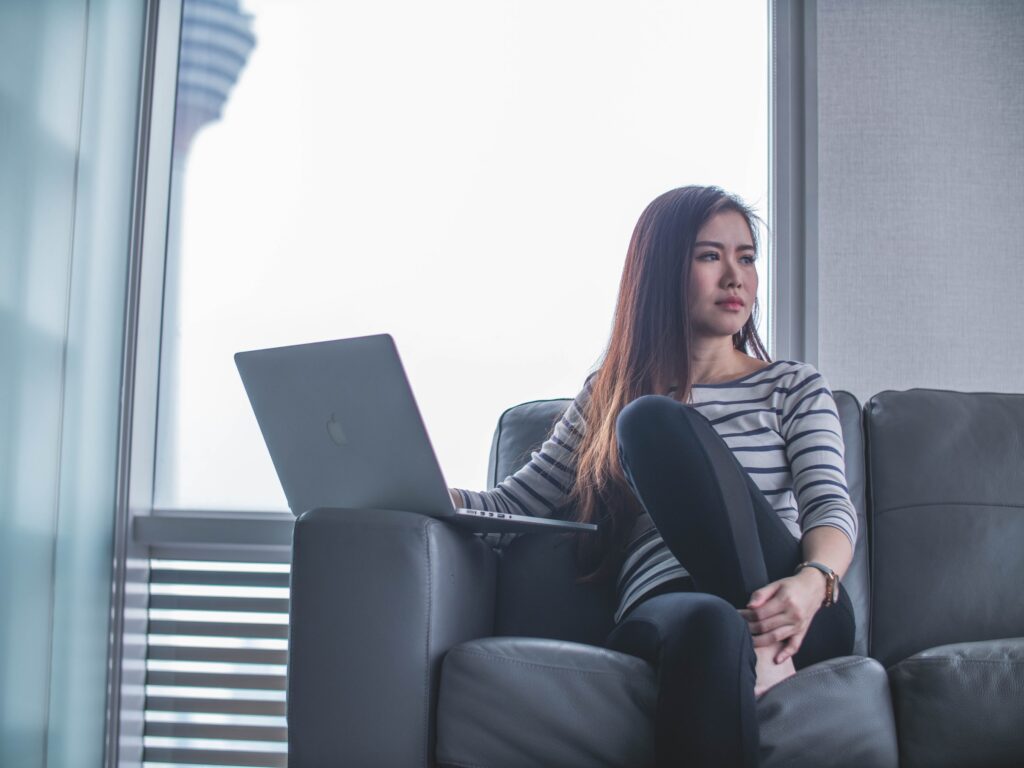 young girl on a sofa with laptop